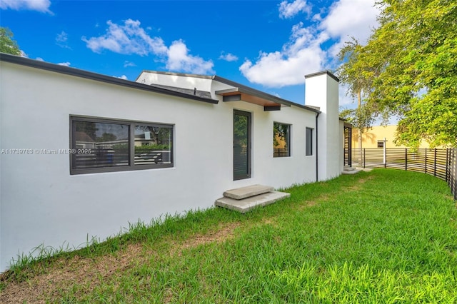 rear view of property featuring a yard