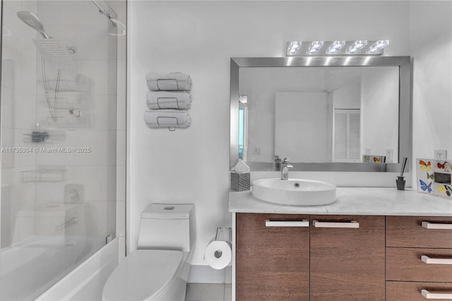 full bathroom with vanity, enclosed tub / shower combo, and toilet