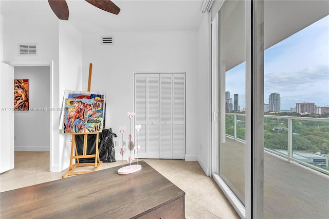 interior space with ceiling fan