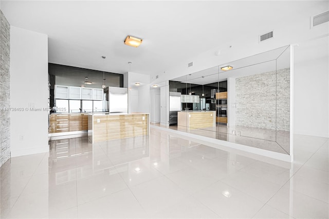 unfurnished living room with tile patterned flooring