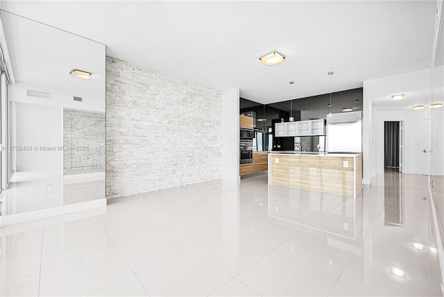 unfurnished living room featuring tile patterned flooring