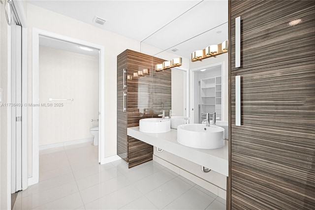 bathroom with vanity, tile patterned floors, and toilet