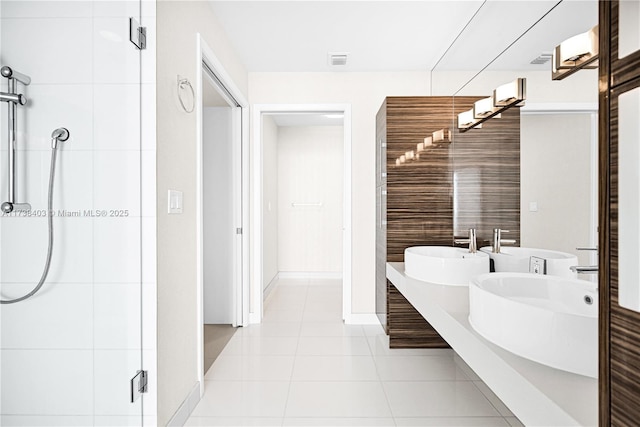 bathroom with an enclosed shower, vanity, and tile patterned floors