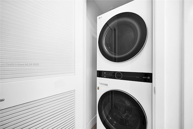 laundry area featuring stacked washer and clothes dryer