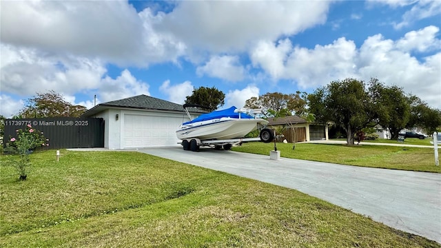 exterior space featuring a garage and a front lawn