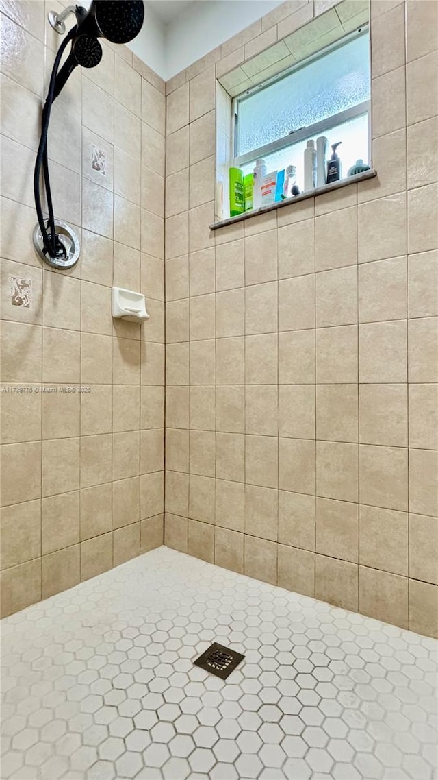 bathroom with a tile shower