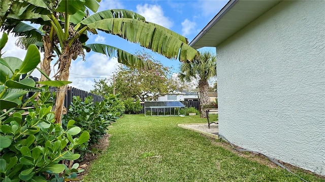 view of yard featuring a trampoline and a fenced backyard