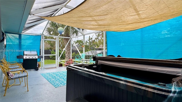 view of patio featuring glass enclosure, area for grilling, and a hot tub