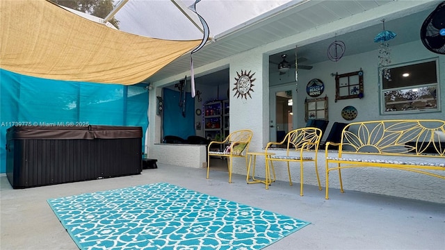 view of patio / terrace featuring a hot tub and ceiling fan