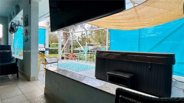 view of patio / terrace with a hot tub, a lanai, and a bar