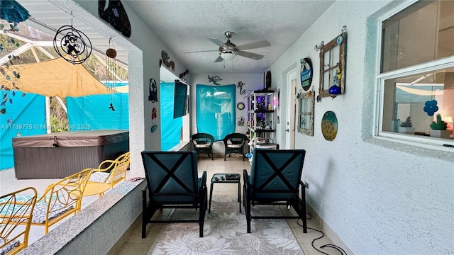 interior space featuring ceiling fan and a textured ceiling