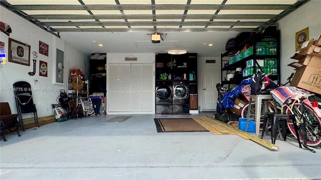 garage with a garage door opener and washer and clothes dryer