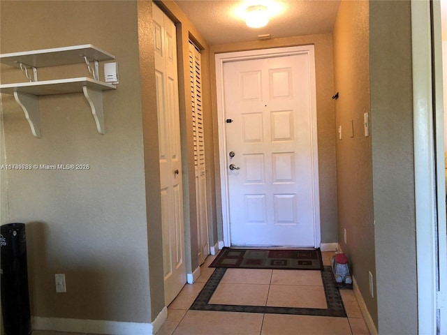 entryway with light tile patterned flooring