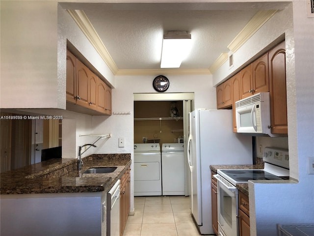 kitchen featuring sink, white appliances, dark stone countertops, independent washer and dryer, and ornamental molding