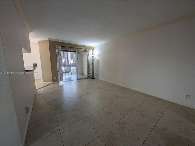 empty room featuring ornamental molding and light tile patterned flooring