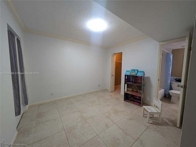 interior space featuring light tile patterned floors, crown molding, and a textured ceiling