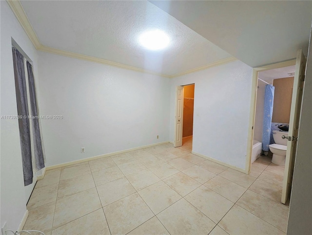 unfurnished bedroom featuring light tile patterned floors, crown molding, and a textured ceiling