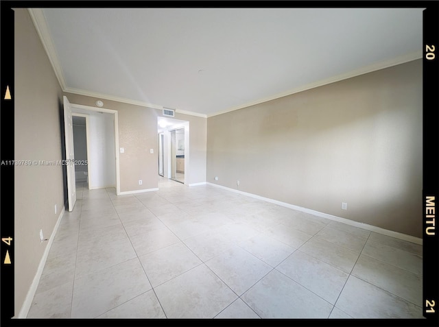 spare room with crown molding and light tile patterned flooring