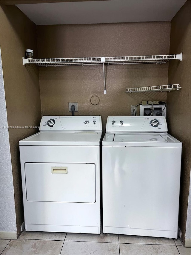 clothes washing area with washing machine and clothes dryer