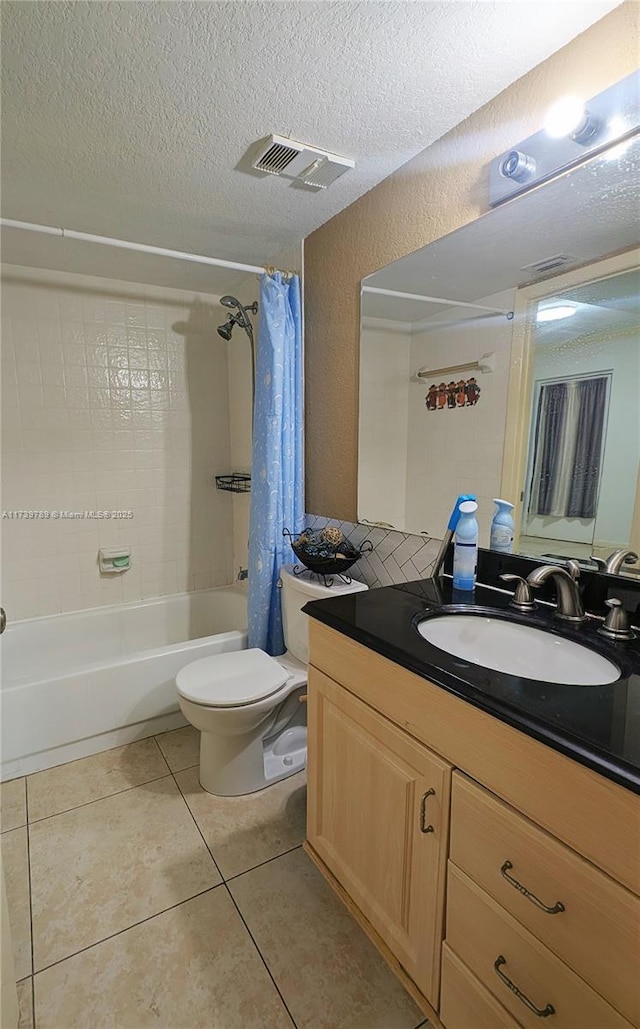 full bathroom with shower / tub combo, vanity, a textured ceiling, tile patterned floors, and toilet