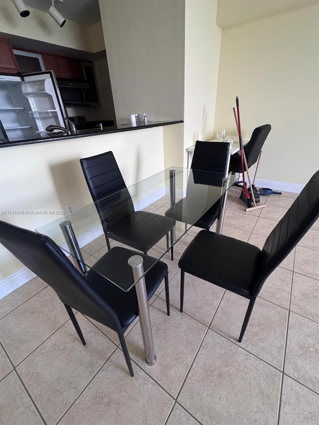 dining area featuring light tile patterned floors