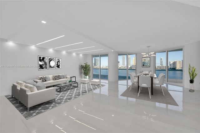 living room with a water view, floor to ceiling windows, and a notable chandelier