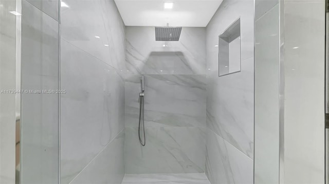 full bath featuring a marble finish shower