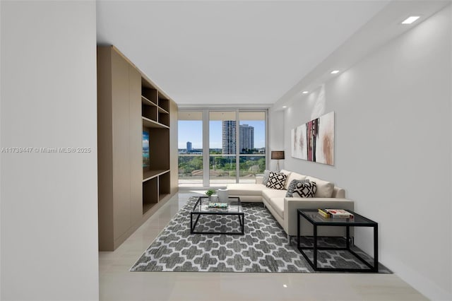 living room featuring a wall of windows, a view of city, and recessed lighting