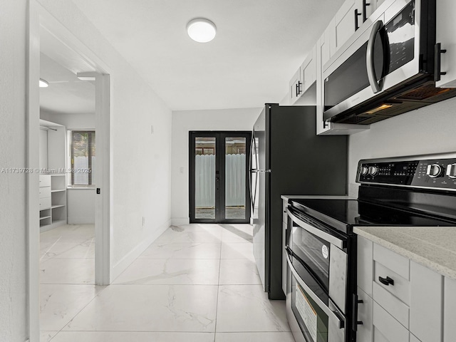 kitchen featuring white cabinetry, stainless steel appliances, and french doors