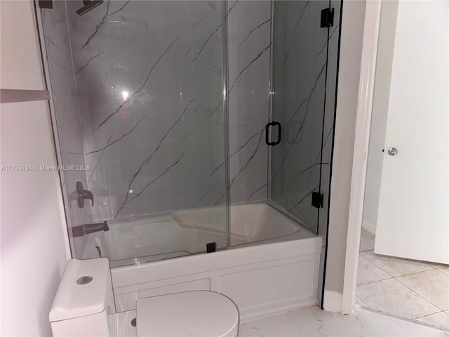 bathroom with toilet and bath / shower combo with glass door