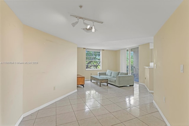 living room featuring light tile patterned floors and rail lighting