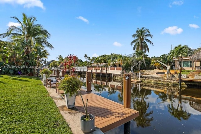 dock area with a water view and a yard