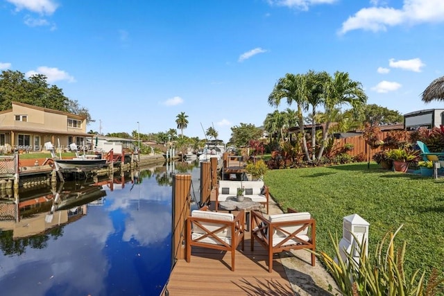 dock area featuring a water view and a lawn