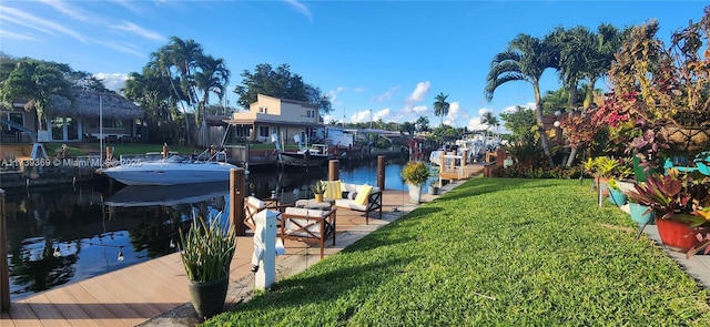 dock area featuring a water view and a yard