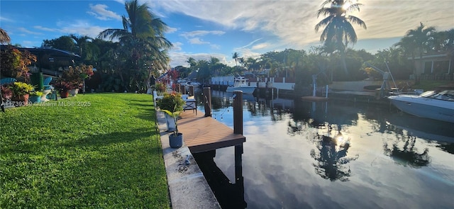 surrounding community with a yard and a boat dock