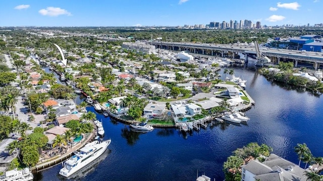 birds eye view of property with a water view and a city view