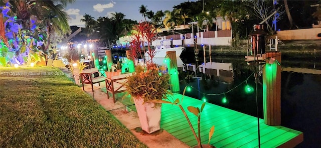 view of playground with a dock and a yard