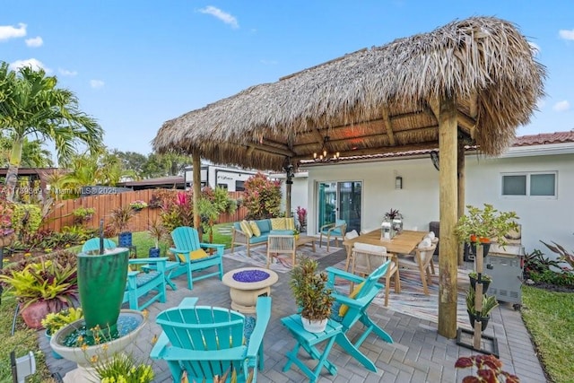 view of patio featuring an outdoor living space with a fire pit