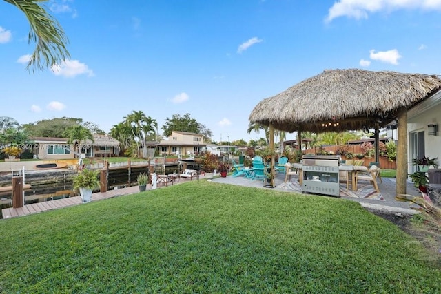 view of yard with a gazebo, a water view, and a patio area