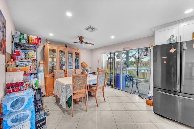 tiled dining area with ceiling fan