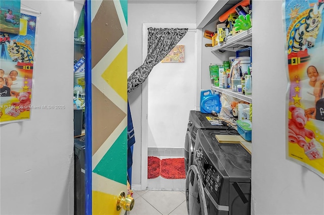 laundry area featuring washer and dryer and light tile patterned floors