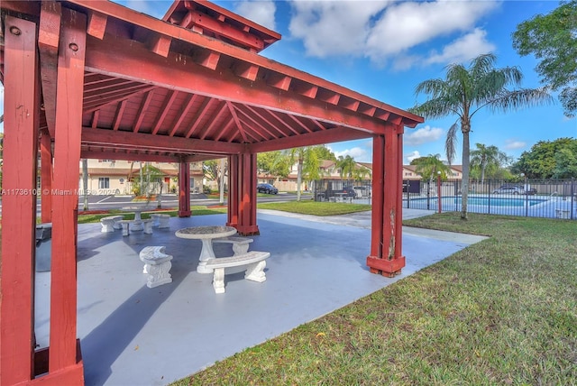 view of community with a gazebo, a patio area, a swimming pool, and a lawn