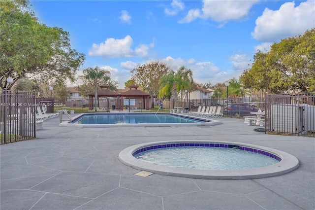 view of pool with a community hot tub and a patio area