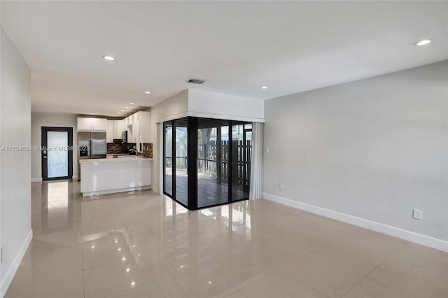 unfurnished room with light tile patterned floors