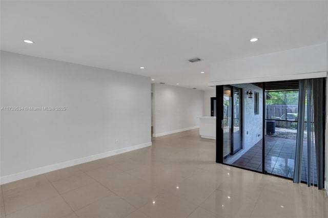 spare room featuring light tile patterned flooring