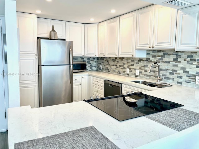 kitchen with white cabinetry, sink, and appliances with stainless steel finishes