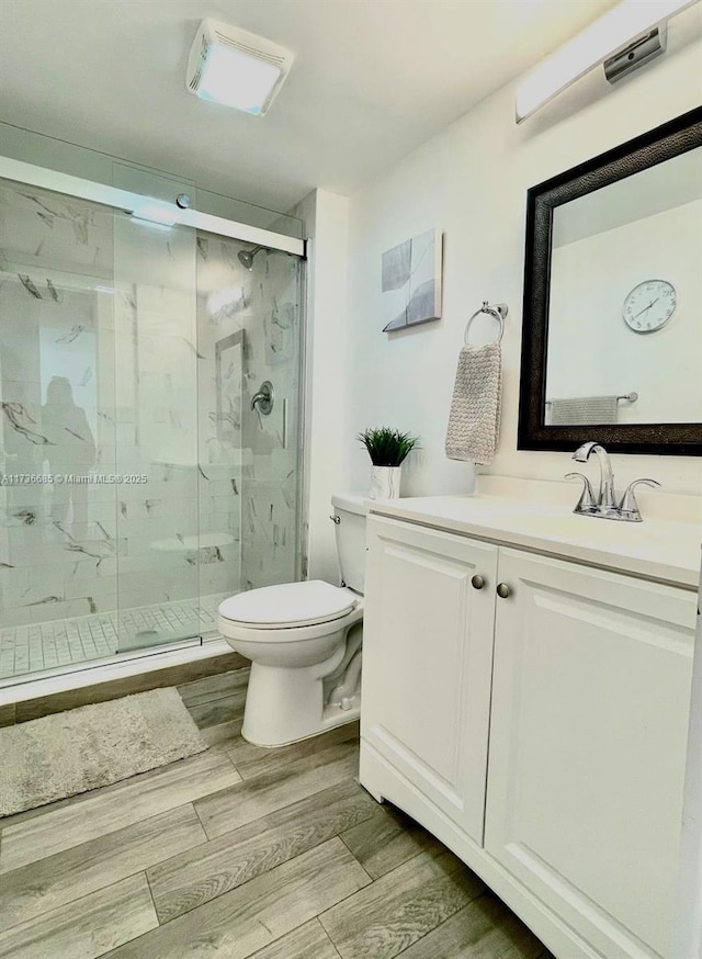 bathroom with vanity, toilet, and walk in shower