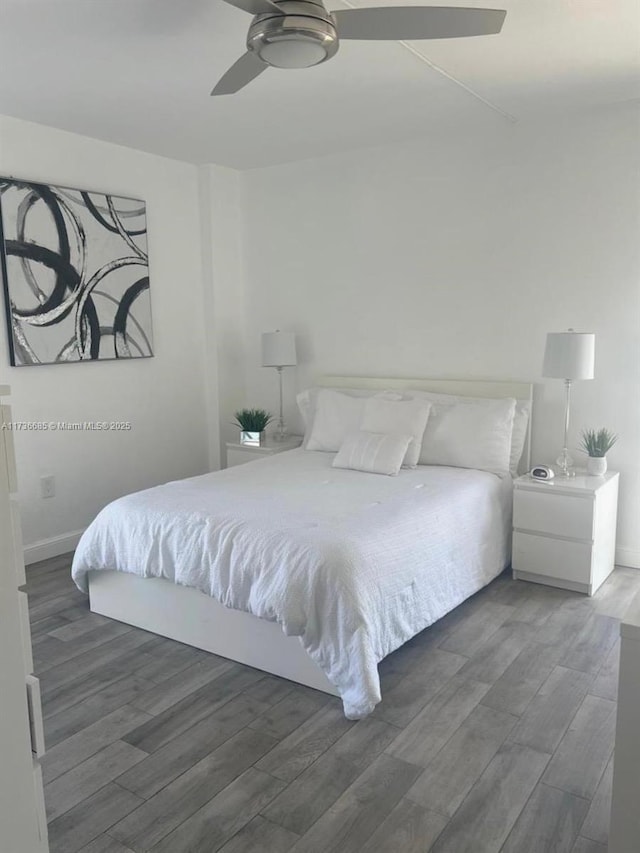 bedroom featuring dark hardwood / wood-style flooring and ceiling fan