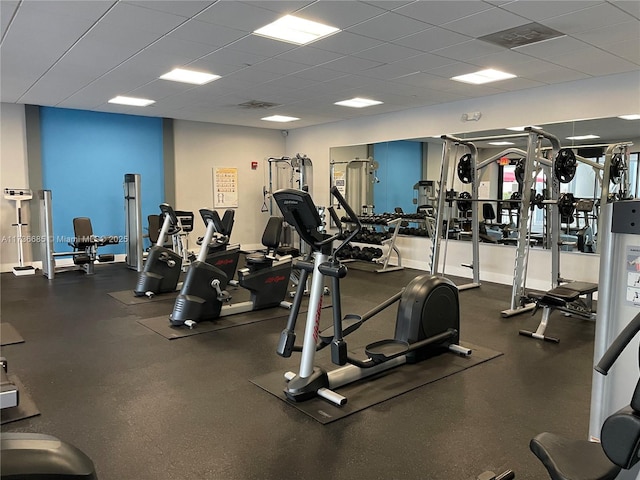 gym with a paneled ceiling