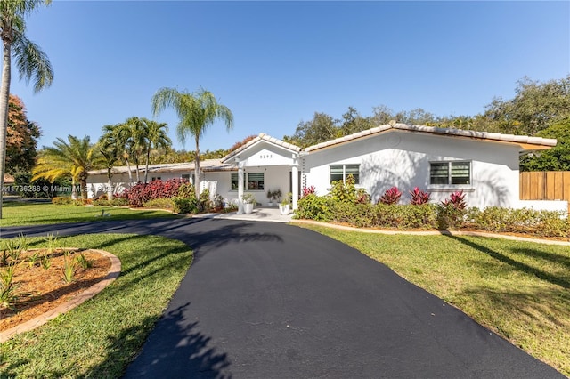 view of front of property with a front yard and stucco siding